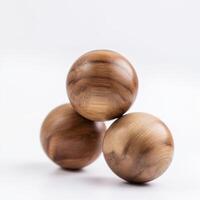 Three wooden balls, balanced in stack, evoke feeling of simple harmony and earthy beauty against stark white background photo