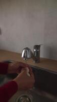 The method of washing eggs properly under a faucet in the kitchen for cleanliness video