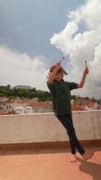 Joyful and playful dance performed on a rooftop high above, surrounded by fluffy clouds video