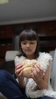 A young girl happily enjoys a piece of fresh, warm bread in a cozy, inviting indoor setting video