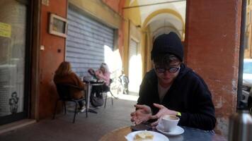 Enjoying a Relaxing Moment at a Charming Cafe with a Warm Beverage and Tasty Snack video