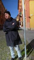 A Casual Individual is Posing at an Urban Setting, Emphasizing a Playful Mood and Style video