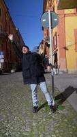 A Joyful Pose by a Street Sign in a Vibrant and Lively Urban Setting Full of Life and Color video