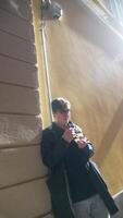 A person enjoys a snack in a vibrant urban setting with a beautiful golden wall background video