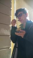Savoring a delightful dessert under the warm sunlight while enjoying the beautiful day video
