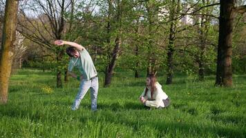 Young adults enjoying a playful moment in nature while taking a break from their activities video