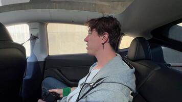 A young individual is happily enjoying a thrilling ride in a beautiful modern vehicle video