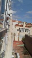 Hanging a Fresh Sheet from the Balcony on a Bright and Sunny Day, Enjoying the Warmth and Light video
