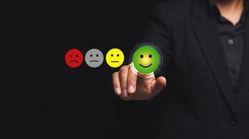 Positive feedback concept. Choosing a green happy mood icon rating review in the survey of customer satisfaction on a virtual screen. photo