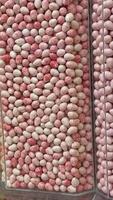 Colorful candy display in a candy shop with assorted sweets in vertical containers video