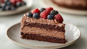 A slice of chocolate cake with berries on top photo