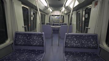Empty metro car in Hamburg, Germany. Featuring modern, clean design with blue patterned seats and sleek handrails. Quiet, futuristic urban transit setting, concepts of travel and city infrastructure. video