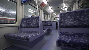 Empty subway car in Hamburg, Germany. Modern, clean and well-lit interior with blue patterned seats and sleek handrails. Quiet, futuristic urban transport scene, travel and infrastructure concepts. video