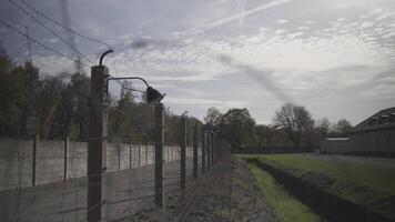 Details of the prison wall. Barbed wire and a lantern. Camp for prisoners. Flashlight and razor wire with electricity hooked up. Theme of imprisonment and police detention. Concentration center. video