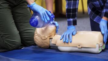 Exercise for life saving in emergency. Demonstration of CPR on manikin. Teaching method pressing on the chest on a dummy in the medical room. video
