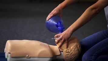 Teaching procedure on a dummy. Medical demonstration of resuscitation on a mannequin in training center. Instructor showing breathing exercise with medical apparatus. video