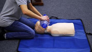Training session for saving life. Instructor shows cardiac exercise on a mannequin. Demonstration of cpr on a dummy with breathing apparatus. video