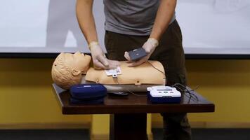 Practical advices for first aid on a mannequin. Trainer demonstrating on a dummy in emergency situation. Training course. video