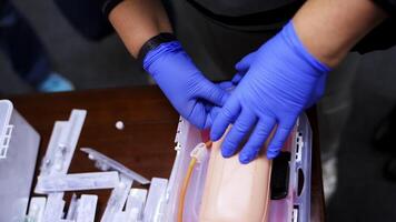 Practical procedure with an injection. Student practices to injection into dummy's hand in the training center. Top view. Close-up. video