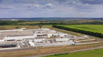 Industry on field. Large territory of industrial plant on green nature background under blue sky. Manufacturing in rural place. Aerial view. video