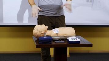 Trainer teaching medical skills on a mannequin. Instructor showing practical methods for giving first aid on a dummy. Healthcare and medical concept. video