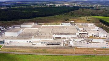 Large industrial territory in nature. Modern plant with car parking from above. Huge manufacturing in the countryside. Aerial view. video
