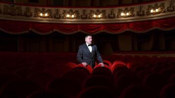 Comedian speaking in dark theater without people. Mad actor shouting in empty theatrical hall and calls someone. Consequences of pandemic. video