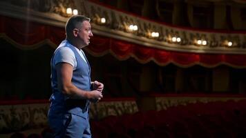 Rehearsal in the theater. Male actor talking from stage to the empty audience during quarantine. Pandemic concept. video