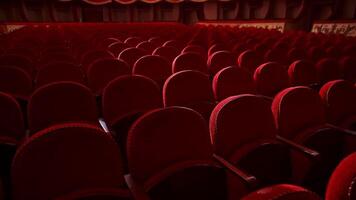 Red velvet chairs in theater hall. Rows of comfortable seats without people. Empty auditorium during pandemic. Slow motion. video