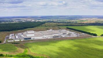 Manufacturing among beautiful nature in summer. Modern technology plant in natural environment. Panoramic view. View from above. video