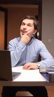 vertical Office worker having an idea while working on laptop video