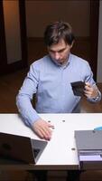 vertical Office worker checking empty wallet at desk with few coins video