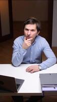 vertical Office worker having an idea while working at his desk video
