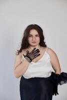 Confident elegant woman in sophisticated black-and-white clothing with a dotted glove posing gracefully, ideal for beauty, fashion editorials, luxury lifestyle visuals, and refined themes photo