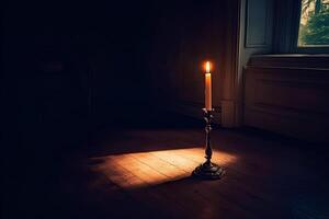 A single lighted candle in a candlestick casting a soft glow in a dark room, creating a peaceful and intimate atmosphere photo