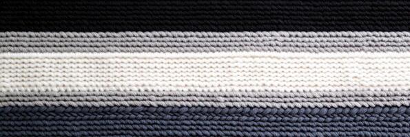 Striped knitted textile with multiple gray and black horizontal layers photo
