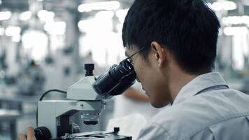 Focused Scientist Using Microscope in Modern Laboratory Setting Industrial Research and Development video
