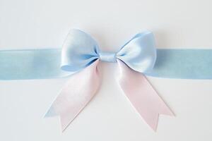 Elegant blue and pink ribbon bow on white background for gift presentation or decor photo