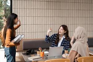 Greetings and Networking. Students exchanging greetings in a friendly study environment at a cafe. photo