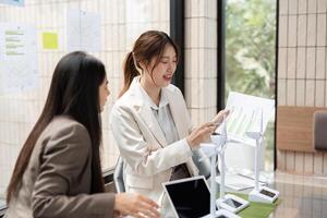 Sustainability and Collaboration. Professionals discussing sustainable practices in an eco-friendly workspace. photo