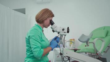Gynecologist uses colposcope, optical device with magnification for detailed examination of cervix, vagina and vulva, helping to diagnose pathologies, detect precancerous changes. Women health. video