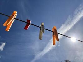 Pegs on the washing line against a sunny sky photo