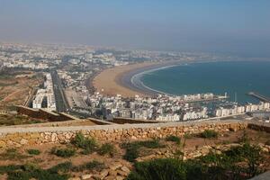 Aerial view of Agadir beach and Agadir port, coastal cityscape in Morocco photo