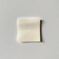 Single Blank Crumpled Sticky Note on Textured Grey White Surface photo