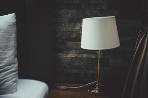 Classic table lamp standing on the bedside table photo