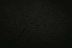 Dark cracked concrete texture with dramatic lighting and deep fissures, perfect for backgrounds, grunge designs, or abstract visual projects photo