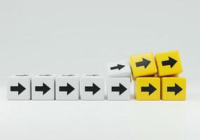 A pile of yellow and black cubes with arrows pointing in different directions photo