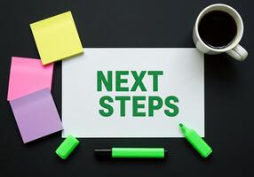 Next steps concept on paper with sticky notes and coffee cup photo