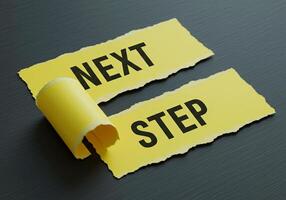 Next step concept on torn yellow paper with black background photo