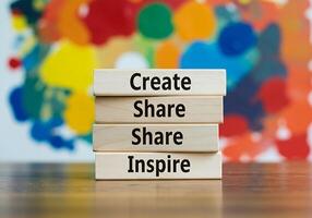 A stack of wooden blocks with the words create share inspire photo